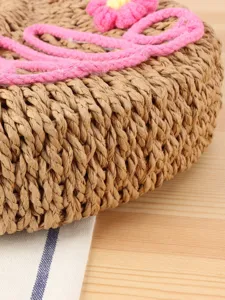 Handmade straw woven handbag for women, casual beach tote bag with cute pink flower and rope decor.