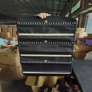 Sac de rangement de bijoux suspendu double face noir avec crochets en métal pour la maison.