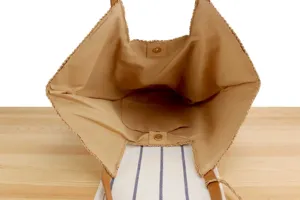 Detailed view of the woven straw tote bag interior showing spacious compartment and lining.