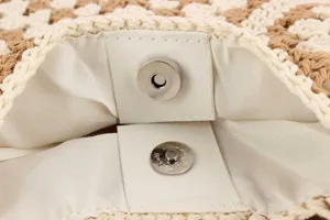 Detailed view of the woven shoulder bag interior showing the magnetic snap closure.