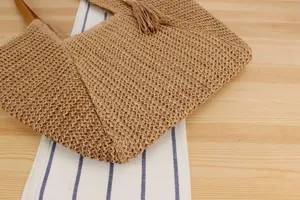 Woven straw tote bag detail showing fine texture, casual style for beach and daily commute.