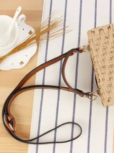 Handmade woven crossbody straw bag with leather strap, casual beach holiday fashion purse.