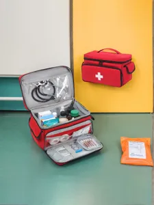 Compact red first aid medical bag with multiple compartments for home and travel emergency use.