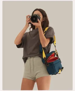 Detailed view of portable mini camera bag with adjustable yellow strap and vibrant interior.