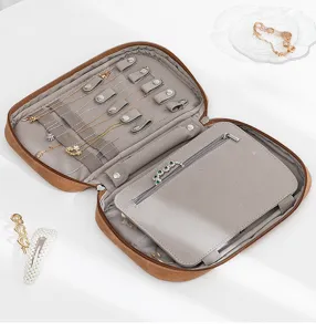 Portable leather jewelry organizer detail shot, compact travel case with storage grids.