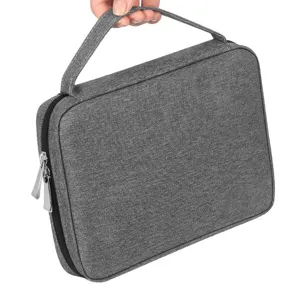 Gros plan sur les details du sac de rangement en tissu gris, poignee et fermeture eclair.