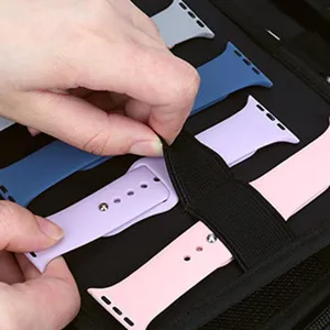 Close-up detail of colorful silicone watch bands neatly organized inside a travel storage case.