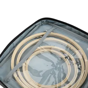 Vista detallada de aros de bordado de madera organizados en una bolsa de tela gris.