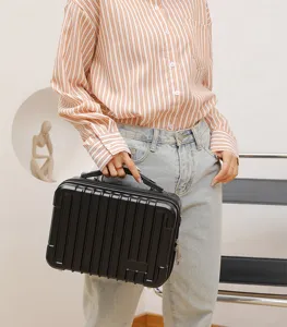 Detail view of the black hard shell mini suitcase storage box with vertical stripes.