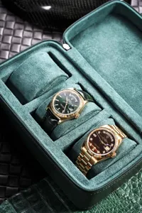 Premium green leather multi-watch travel case with soft suede interior lining detail.