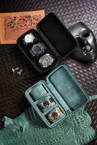 Close-up view of portable travel watch storage box featuring multiple slots and velvet lining.
