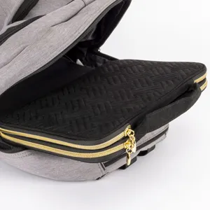 Detailed view of gray backpack with black textured organizer pouch and golden zippers.