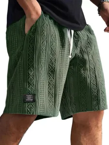 Close-up detail of mens dark green knitted jacquard casual shorts with white drawstring.