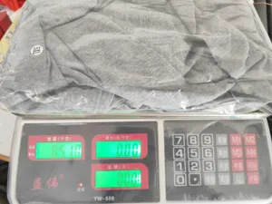 Detailed view of the summer dress packed in a transparent bag on a digital scale.