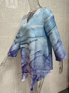 Details of the blue gradient V-neck long sleeve casual oversized blouse with irregular hem.