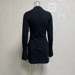 Back view detail of a sleek black long sleeve bodycon mini dress with flared cuffs.