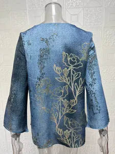 Blue long sleeve V-neck top back view detail showing elegant gold floral print and loose fit.
