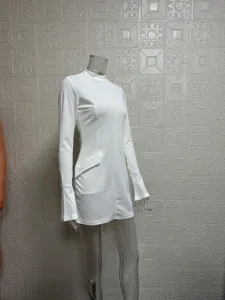 Close-up detail of the elegant white long-sleeve fitted mini dress, showcasing the sleek collar.