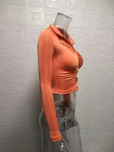 Orange slim long sleeve crop shirt detail view, showing collar and button-up design.