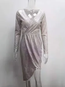Detailed view of the sparkling long-sleeve V-neck evening dress with irregular hem design.
