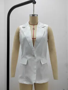 Close-up detail of a white sleeveless blazer featuring a classic lapel and single button.