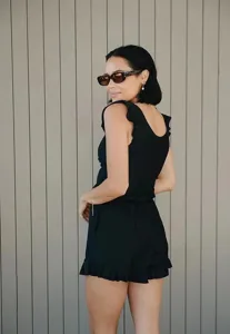 Black sleeveless ruffled women swimsuit detail shot showcasing stylish design and comfort.