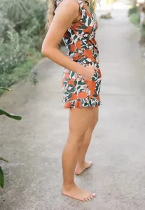 Detail shot of women summer floral print romper featuring ruffles and convenient side pockets.