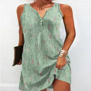 Close-up of the sleeveless V-neck dress, showing the light green abstract floral print.