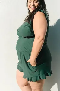 Plus-size dark green one-piece romper swimsuit with ruffle straps and built-in bra.