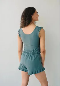 Ruffled one-piece swimsuit detail, featuring sleeveless design, built-in bra and soft teal fabric.