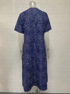 Back detail of blue short-sleeve midi dress with white abstract dots pattern on mannequin.