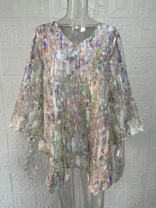 Detail view of abstract multi-color print loose V-neck long sleeve blouse, fabric texture.