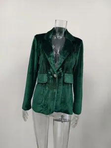 Detail shot of elegant dark green velvet blazer featuring a decorative lion head button