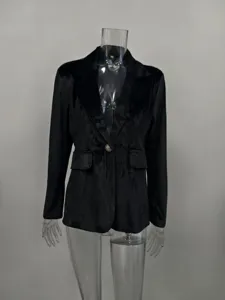 Close-up of elegant black velvet slim-fit blazer with single gold button detail.