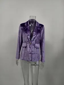Close-up of a luxurious purple velvet slim-fit blazer with elegant gold button detail.