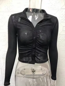 Black sheer long sleeve button down crop top detail showing collar and fabric texture.