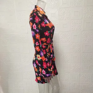 Floral print long sleeve shirt dress with belt, side view showcasing pleated mini skirt.