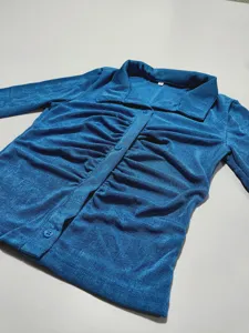 Blue long sleeve button-down shirt with elegant collar and stylish ruched front design.