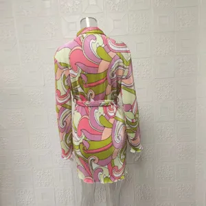 Women's retro psychedelic abstract print long sleeve belted pleated mini shirt dress detail.