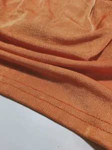 Orange knit fabric texture detail shot for women casual stylish cardigan shirt top