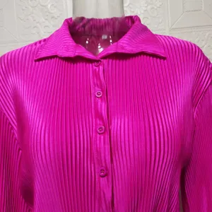 Vibrant hot pink pleated women's long sleeve shirt with classic lapel collar and front buttons.