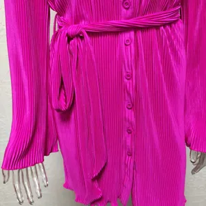 Magenta pleated long sleeve shirt dress detail, stylish women's belted dress close up view.