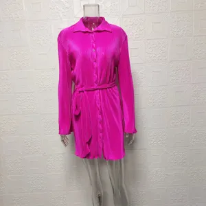 Pink pleated long sleeve shirt dress for women detail view featuring waist belt and button closure.