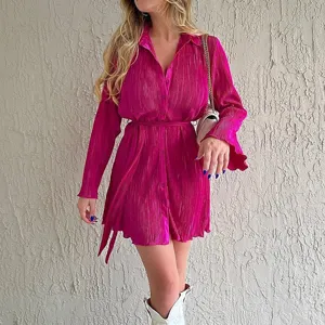 Close-up detail of the shiny pleated long-sleeve shirt dress with chic belt and button front.