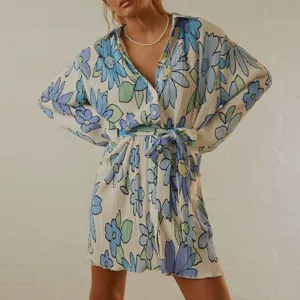 Floral print pleated shirt dress with long sleeves and matching waist belt for women.
