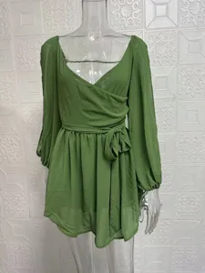 Green chiffon long sleeve wrap mini dress detail view, elegant casual party wear outfit.