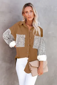 Close-up detail of women's autumn corduroy shirt featuring leopard print sleeves and pockets.