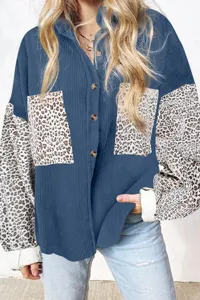 Blue corduroy shirt detail showing leopard print long sleeves and chest pocket design.