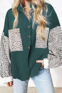 Detail shot of women's corduroy leopard patch shirt, featuring lapel collar and buttons.