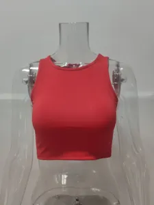 Close-up detail of the red sleeveless crop top, showing the round neckline and fabric texture.